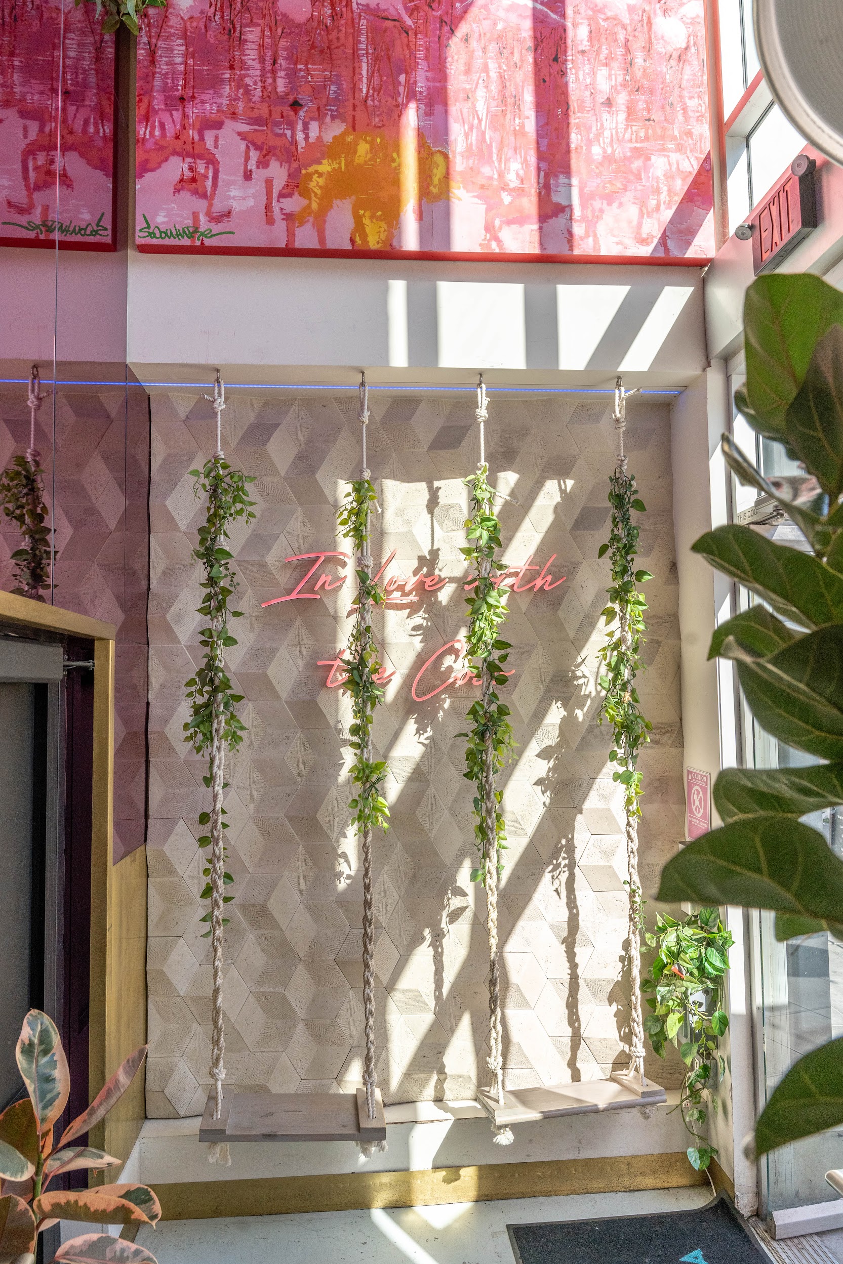 Coco Maya interior — In Love with the Coast neon wall